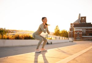 Woman doing squats outside.