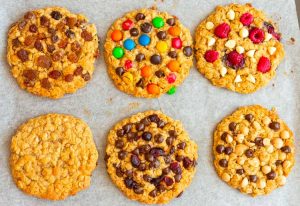 Six breakfast cookies on a tray with different toppings.