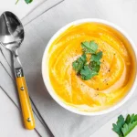 Bowl of cheesy pumpkin soup.