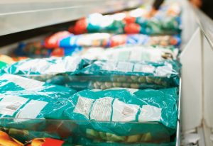 Packaged frozen food in a supermarket freezer.