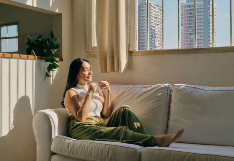 Perimenopausal woman sitting a couch.