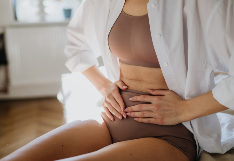 Woman holding her stomach.