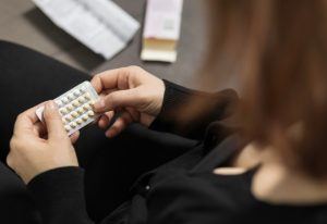 Woman taking hormone replacement therapy medication