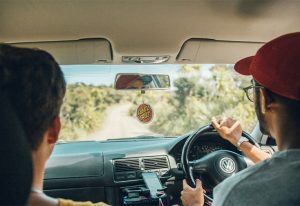 Two men driving in a car.