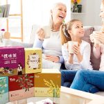 Family on sofa enjoying Taste For Life herbal tea.