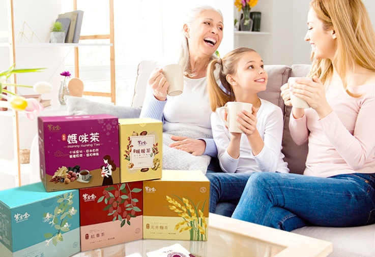 Family on sofa enjoying Taste For Life herbal tea.