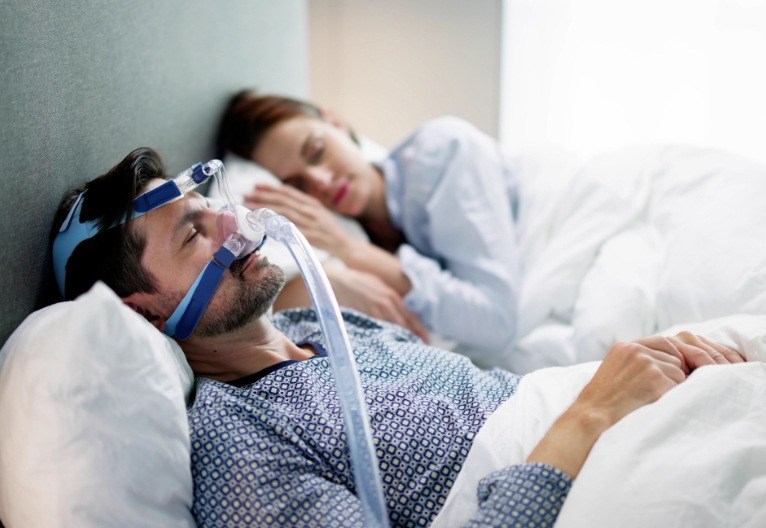 Man sleeping with an oxygen mask.