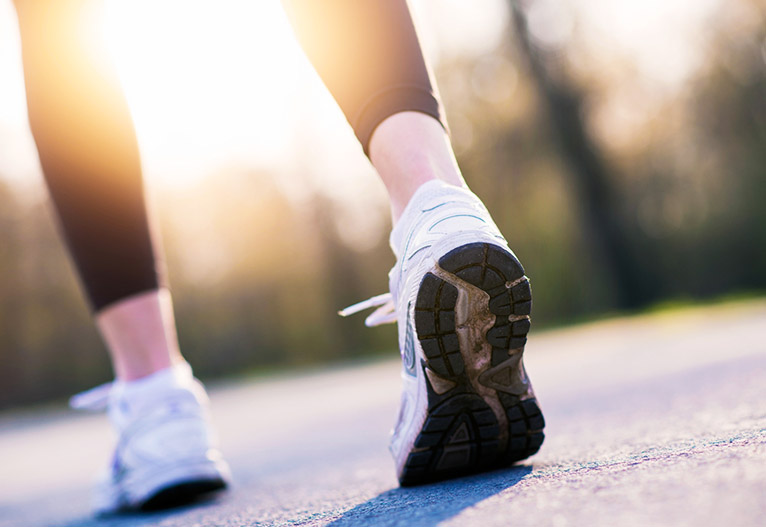 Woman walking in sneakers.