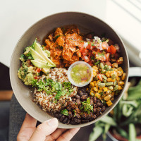 Person holding a bowl of healthy food.