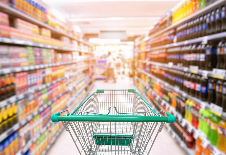 A trolley in a supermarket aisle.
