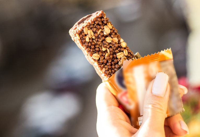 Person holding a protein bar.