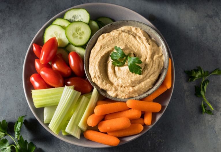 Plate of vegetables and hommus.