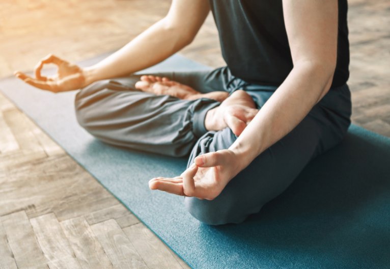Man sitting in a yoga pose.