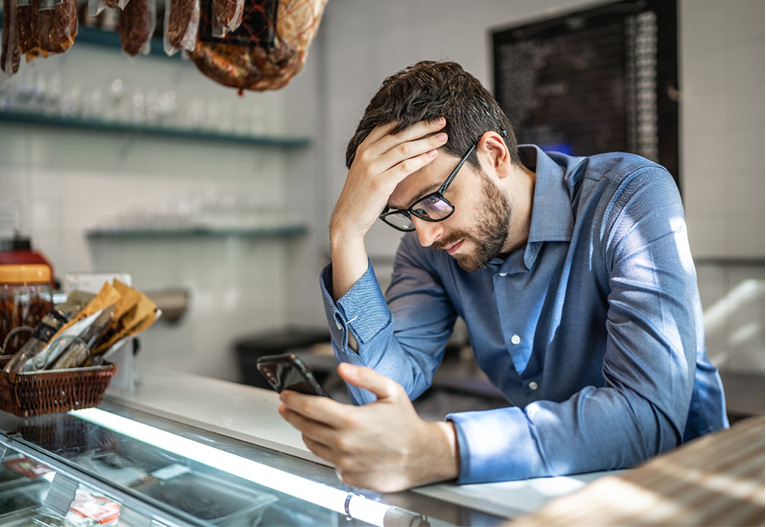 Worried man looking at his phone.