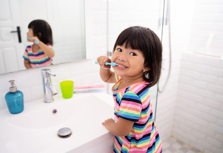 Child brushing her teeth.