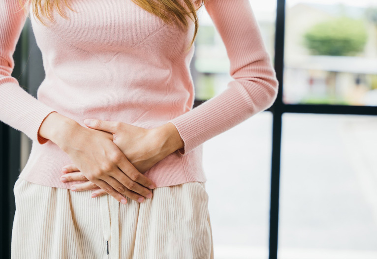Woman holding her stomach.