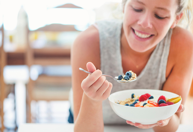 Woman eating breakfast.