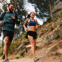 Man and woman jogging in the bush.