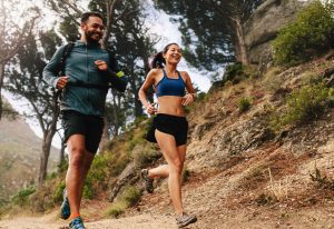 Man and woman jogging in the bush.