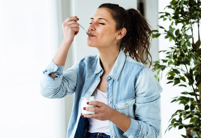 Woman eating yoghurt.