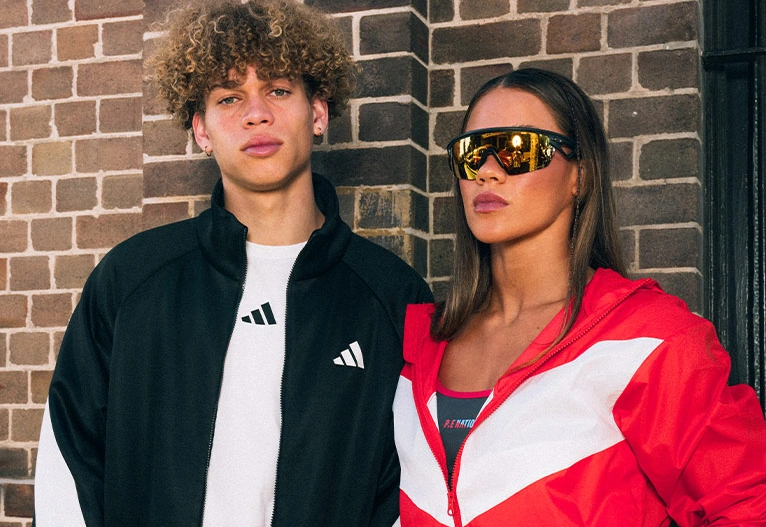 Young man and woman in urban sports apparel.
