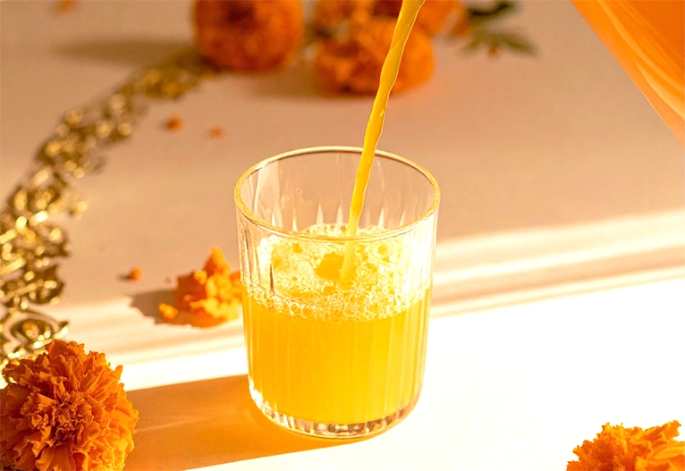 Orange juice being poured into a glass.