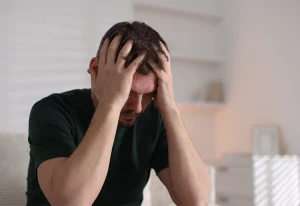 Man with his head in his hands.