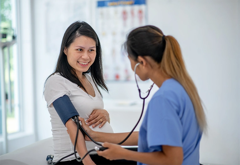 Woman having her blood pressure checked by a docture.